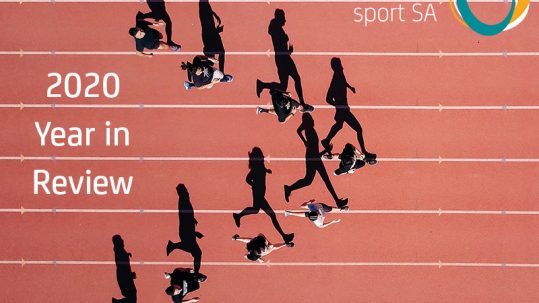 Image of a group of people each running in a lane on an athletics track behind the on the track text says 2020 Year in Review. The Inclusive Sport SA logo appears in the top right hand corner.
